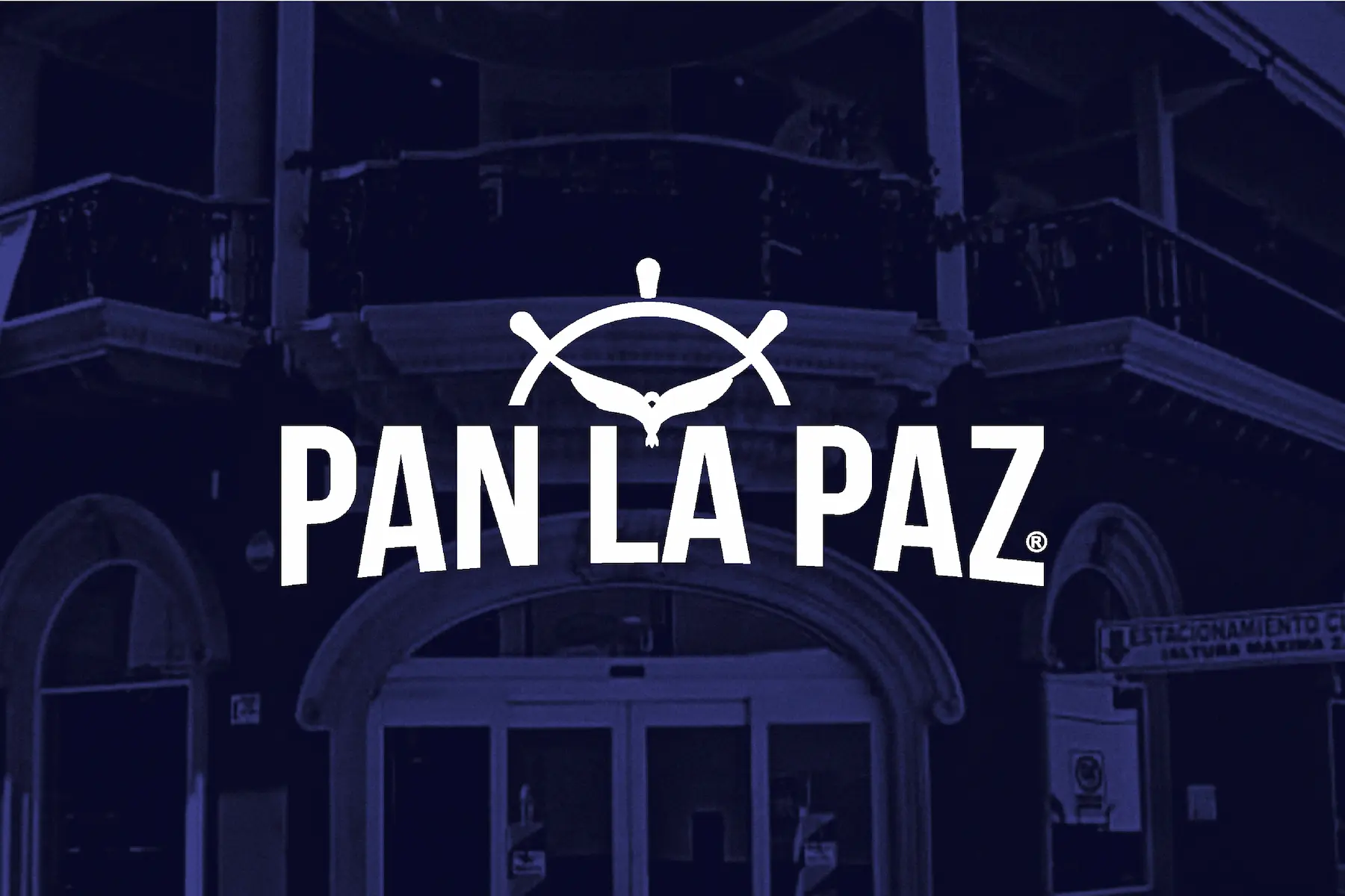 Logotipo de Pan La Paz sobre fondo azul oscuro